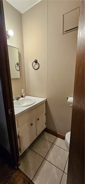 bathroom with vanity, toilet, and tile floors