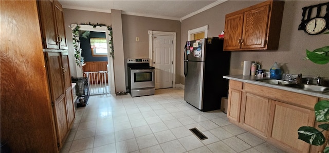 kitchen featuring crown molding, sink, light tile floors, and appliances with stainless steel finishes