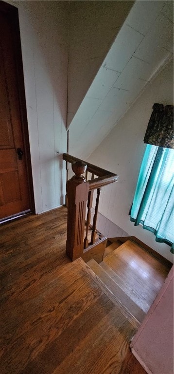 stairs featuring hardwood / wood-style floors