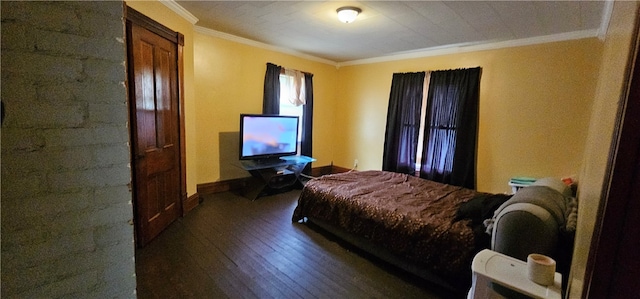 bedroom with ornamental molding and dark hardwood / wood-style flooring