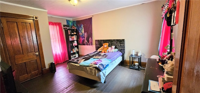 bedroom featuring crown molding and dark wood-type flooring