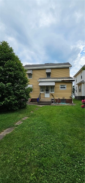 back of house with a lawn