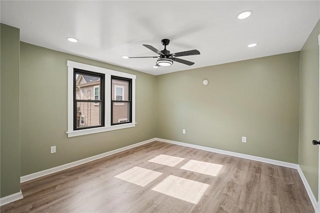 spare room with ceiling fan and light wood-type flooring