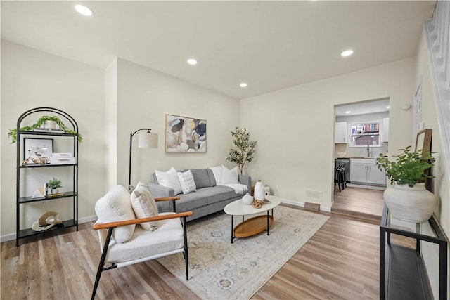 living room with light hardwood / wood-style flooring