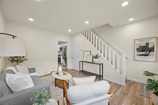 living room with light hardwood / wood-style flooring