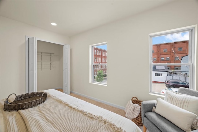 bedroom featuring multiple windows, a closet, and carpet floors