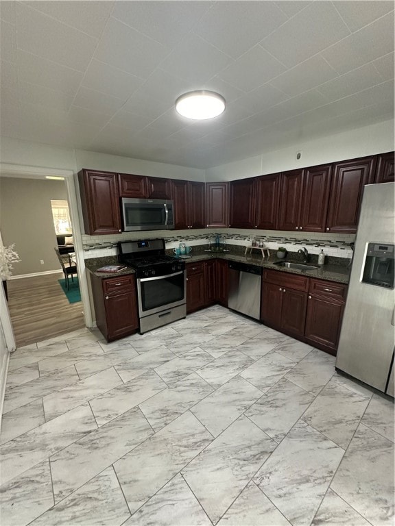 kitchen with sink, light tile floors, and appliances with stainless steel finishes