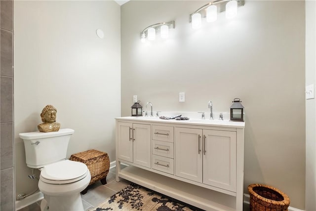 bathroom featuring tile patterned flooring, vanity, and toilet