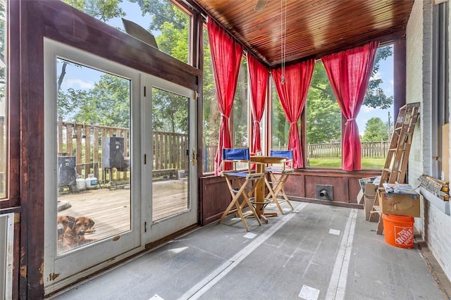 unfurnished sunroom with wooden ceiling