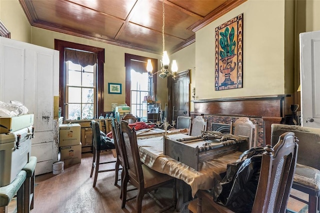 bedroom featuring wood-type flooring, wooden ceiling, an inviting chandelier, and crown molding