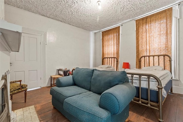 sitting room featuring wood-type flooring and a textured ceiling