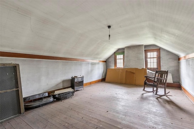 bonus room featuring lofted ceiling and light wood-type flooring