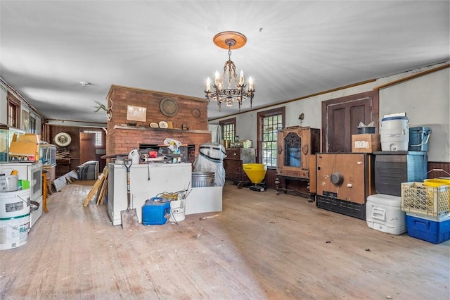 interior space featuring an inviting chandelier, light hardwood / wood-style flooring, and ornamental molding