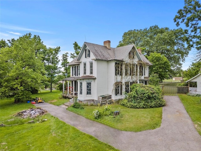 view of property exterior with a porch and a yard