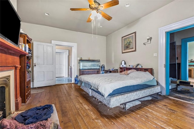 bedroom with hardwood / wood-style floors and ceiling fan