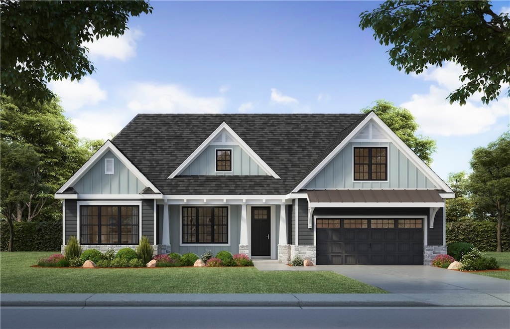 view of front of property featuring a garage and a front lawn