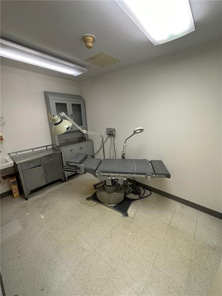 interior space featuring baseboards and tile patterned floors