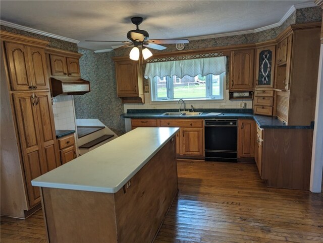 kitchen featuring dark hardwood / wood-style floors, a kitchen island, ceiling fan, black dishwasher, and sink