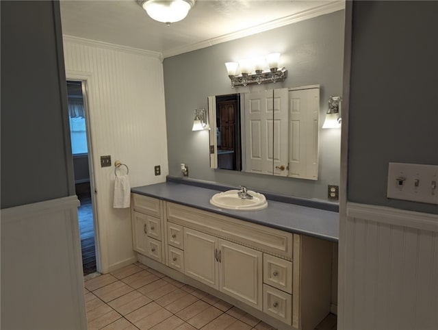 bathroom with crown molding, vanity, and tile floors