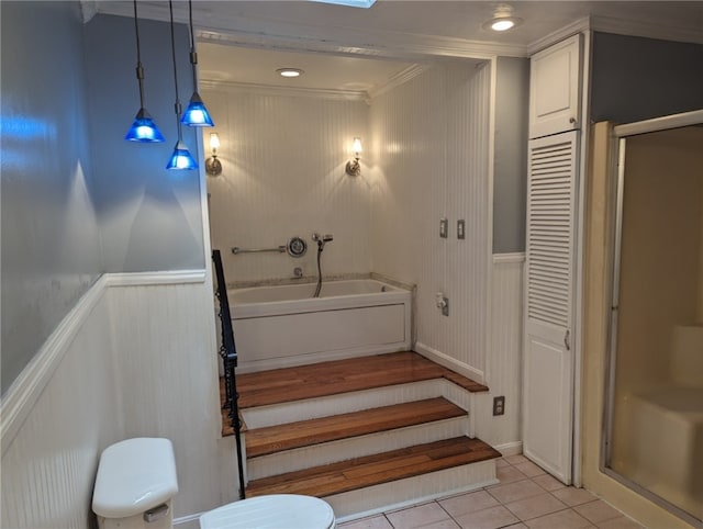 interior space featuring tile flooring, independent shower and bath, toilet, and ornamental molding