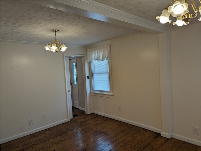 spare room featuring a notable chandelier, hardwood / wood-style floors, and crown molding