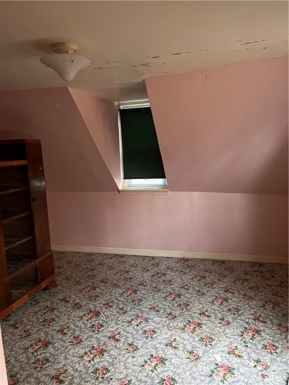 additional living space featuring lofted ceiling