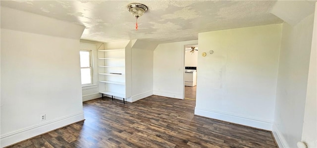 empty room with a textured ceiling and dark wood-type flooring