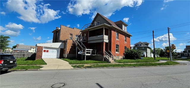 view of front of property with an outbuilding, a garage, and a front yard