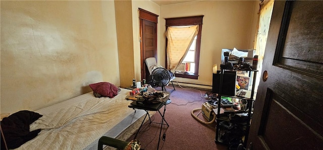 carpeted bedroom featuring a baseboard heating unit