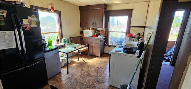 kitchen with white appliances and a drop ceiling