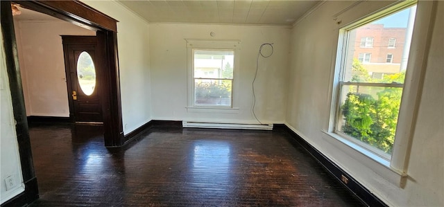 foyer with dark hardwood / wood-style flooring, crown molding, and a baseboard heating unit