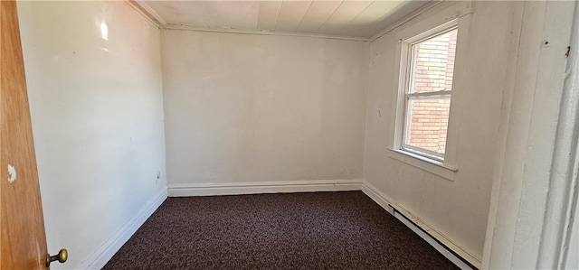 carpeted empty room featuring baseboard heating and a wealth of natural light