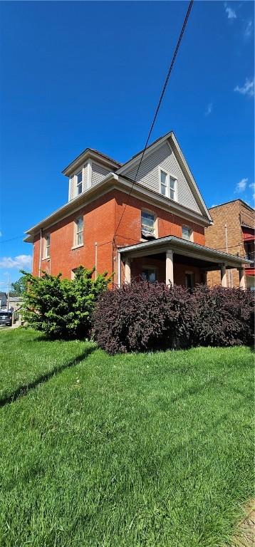 view of side of home featuring a yard