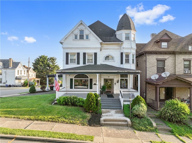 victorian home featuring a front lawn and covered porch