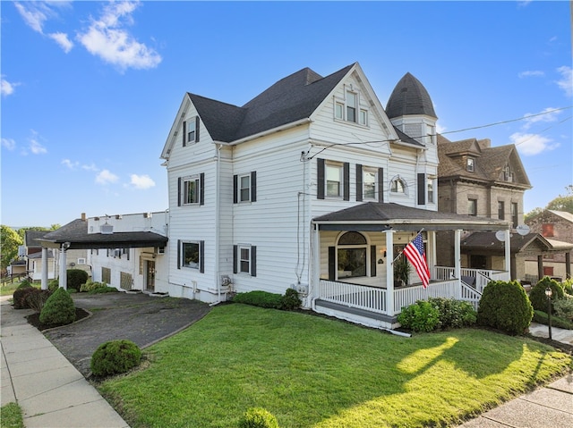 view of front facade with a front lawn and a porch