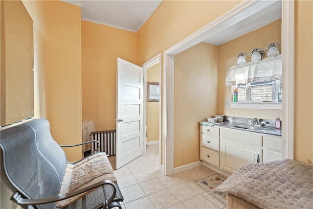 bathroom featuring crown molding, tile patterned flooring, radiator, and vanity