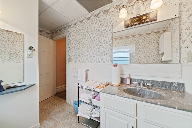 bathroom with a paneled ceiling, vanity, and tile patterned floors