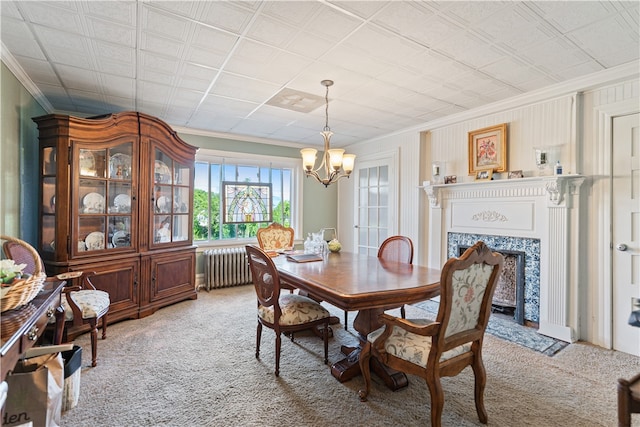 dining area featuring an inviting chandelier, radiator, a premium fireplace, and light colored carpet