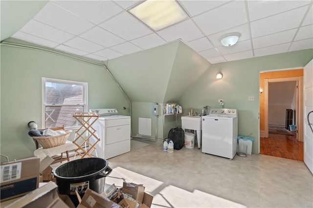 washroom with light wood-type flooring, washer and dryer, and sink