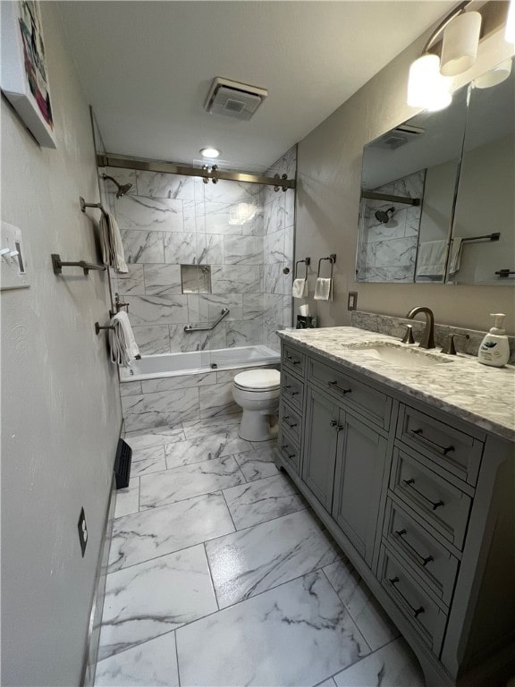 full bathroom with vanity, tiled shower / bath combo, toilet, and tile patterned floors