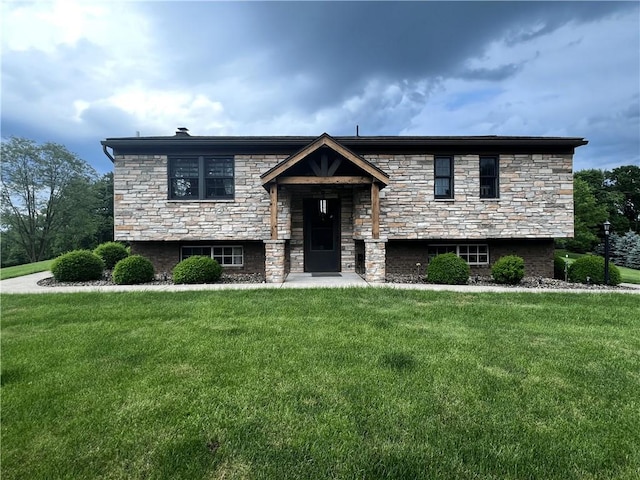 split foyer home with a front lawn