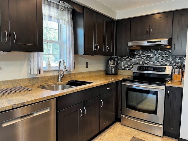 kitchen featuring sink, appliances with stainless steel finishes, light stone countertops, and decorative backsplash