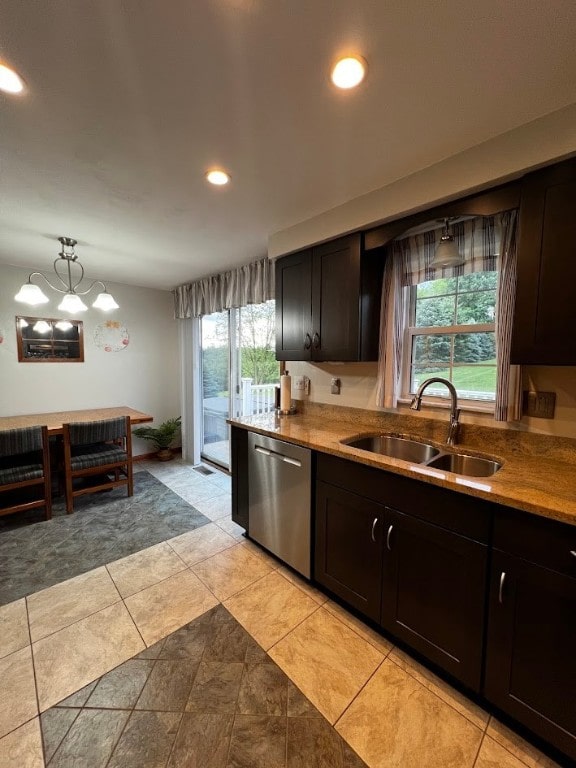 kitchen featuring light tile patterned flooring, stainless steel dishwasher, sink, and a wealth of natural light