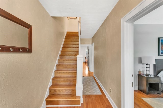 stairway with hardwood / wood-style floors