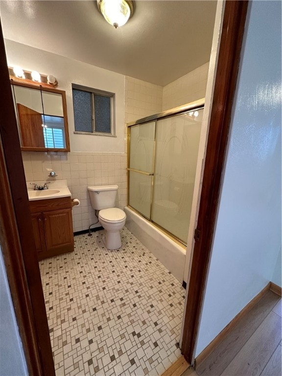 bathroom with tile walls, oversized vanity, toilet, tile floors, and tasteful backsplash