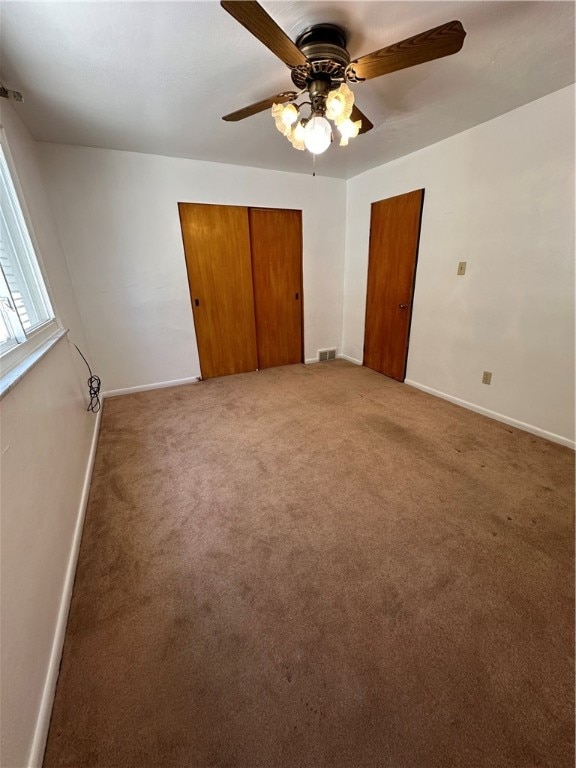 unfurnished bedroom featuring ceiling fan and carpet floors