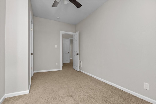 unfurnished bedroom featuring ceiling fan and light colored carpet