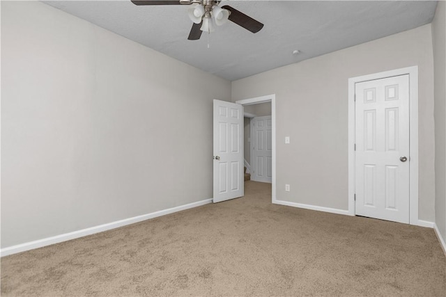 unfurnished bedroom featuring ceiling fan and light carpet