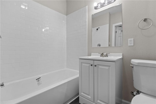 full bathroom featuring vanity, bathtub / shower combination, and toilet