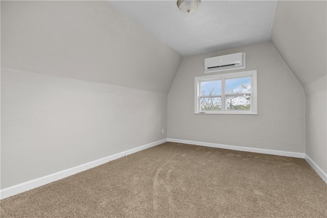 additional living space featuring carpet floors, a wall mounted air conditioner, and vaulted ceiling